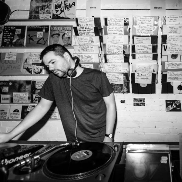 Photograph of Sean McCabe playing records in a record shop